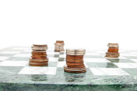 coin chess pieces on the board, on whiteの写真素材