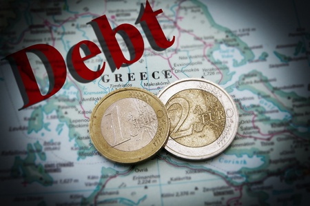 Euro coins on a map of Greece with Debt text (Greek financial crisis)の写真素材