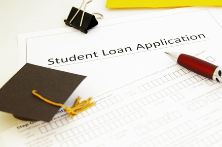 student loan application form and mini graduation  capの写真素材