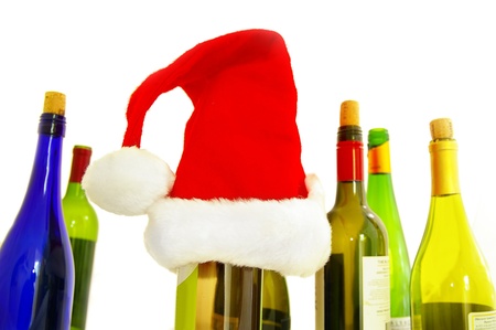 assorted wine bottles and a santa hat, on whiteの写真素材