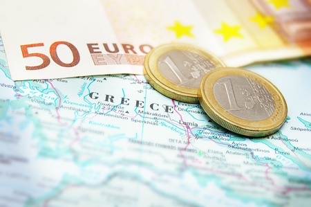 Closeup of Euro coins on a map of Greeceの写真素材