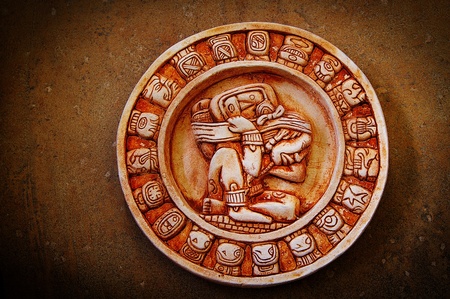 A carved Mayan calendar on textured backgroundの写真素材