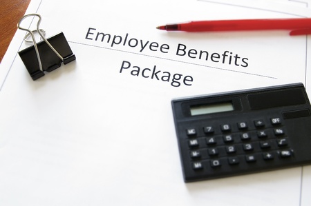 employee benefits package with calculator and penの写真素材