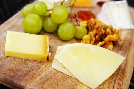 gourmet cheese plate with fruit and walnutsの写真素材