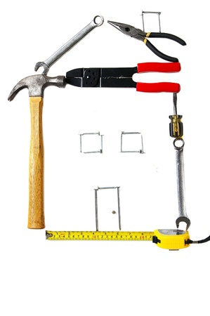 assorted tools in the form of a house, isolated on whiteの写真素材