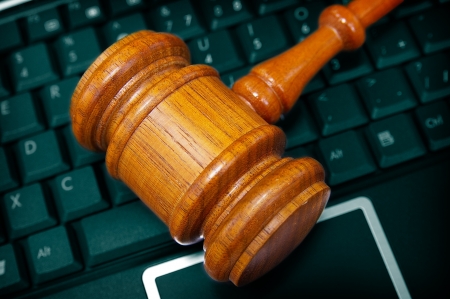 court gavel on a PC laptop keyboardの写真素材