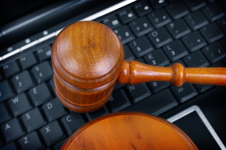 court gavel on laptop computer keyboardの写真素材