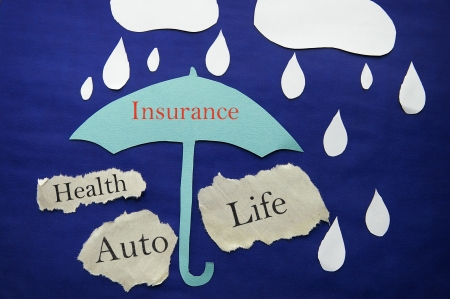 paper umbrella and rain with insurance themed messagesの写真素材