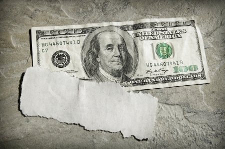 torn piece of blank newspaper scrap on US moneyの写真素材