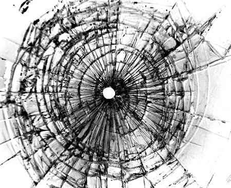 Broken window with a bullet hole in the middle                               の写真素材