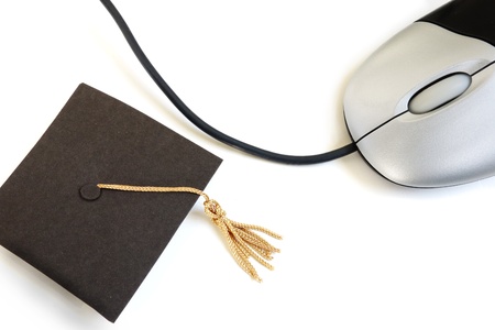 Mini graduation cap and computer mouse, on white                               の写真素材