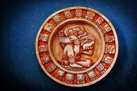 A carved Mayan calendar on textured backgroundの写真素材
