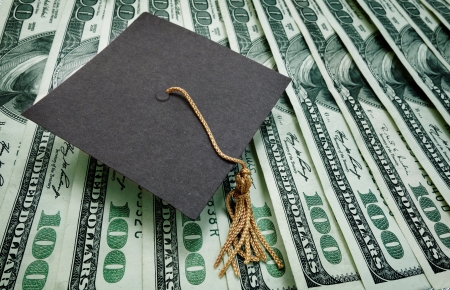 graduation cap on assorted hundred dollar bills - education concept                               の写真素材
