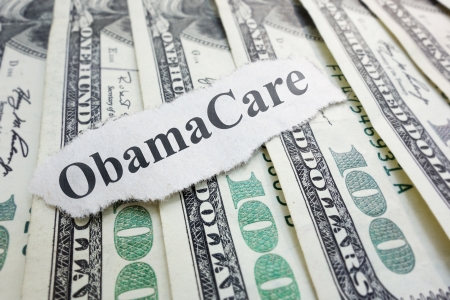 Closeup of an Obamacare newspaper headline on cash                              の写真素材