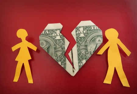 paper couple on broken dollar heart                                の写真素材