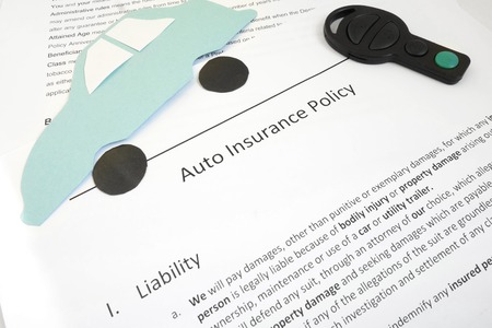 Auto insurance policy and key with paper car                               の写真素材