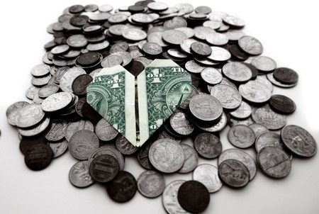 Origami heart shaped dollar on a pile of coins                               の写真素材