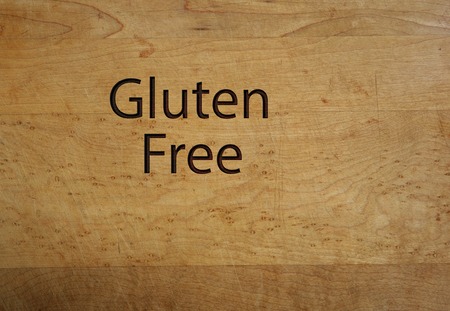 Gluten Free text on a wooden cutting board - food allergy conceptの写真素材
