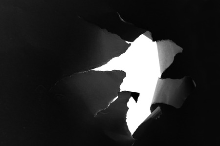 Side view of a torn jagged hole in paperの写真素材