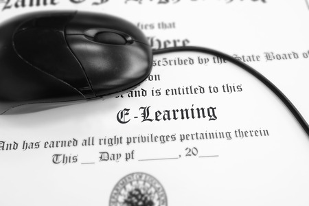 E-Learning diploma with computer mouse - distance learning conceptの写真素材