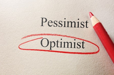 Red pencil circle around Optimism, vs Pessimismの写真素材