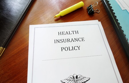 Health Insurance Policy on an office deskの写真素材