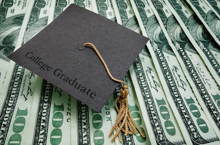College Graduate cap on assorted hundred dollar billsの写真素材