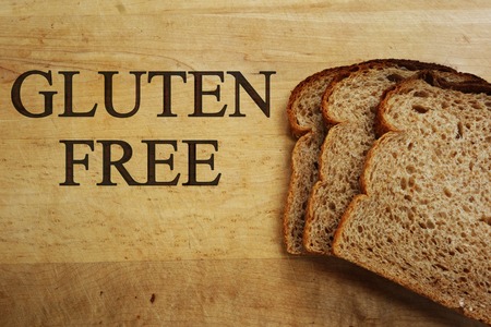 Gluten Free on cutting board with bread slicesの写真素材
