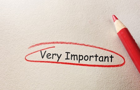 Very Important text circled in red pencil, on textured paperの写真素材
