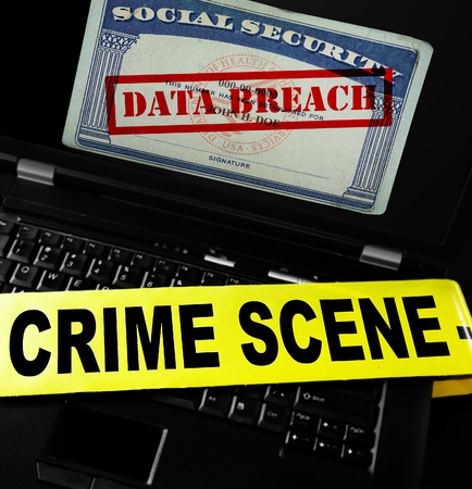 Data Breach text on Social Security card with crime scene tape on laptop computerの写真素材