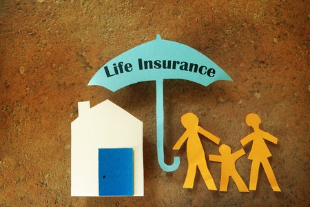 Paper cutout family with house under a Life Insurance umbrellaの写真素材