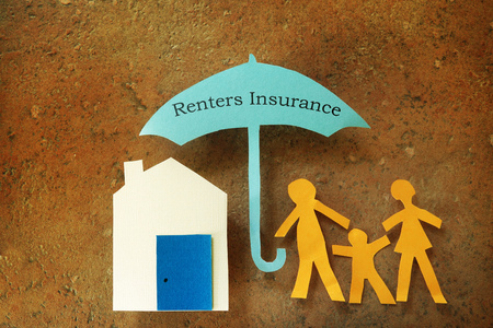 Paper cutout family with house under Renters Insurance umbrellaの写真素材