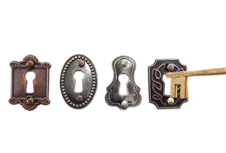 Antique locks with gold key isolated on whiteの写真素材