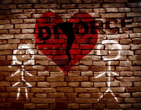 Stick figure couple on brick wall with broken red heart and divorce textの写真素材