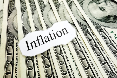 Inflation newspaper headline on hundred dollar billsの写真素材