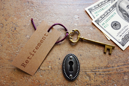 Vintage gold key with Retirement tag with keyhole and moneyの写真素材