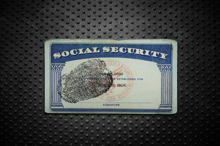 Social Security card with fingerprint on textured metal backgroundの写真素材