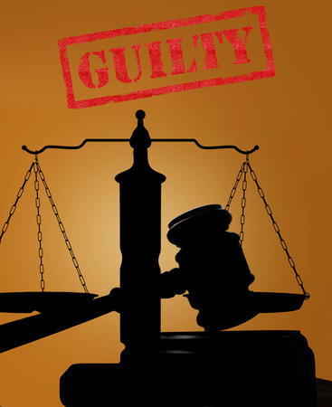 Court gavel and scales of justice silhouette with Guilty textの写真素材