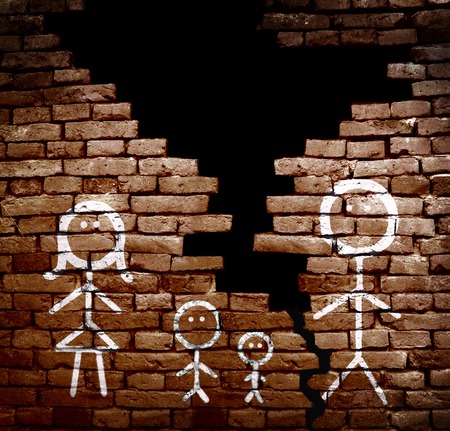 Family of stick figures on broken brick wall -- divorce or separation conceptの写真素材