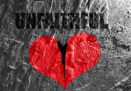 Red heart on textured background with Unfaithful textの写真素材