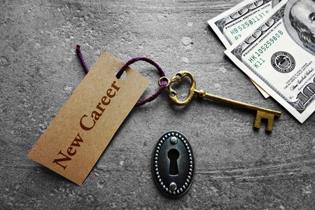 Vintage key with New Career tag and moneyの写真素材