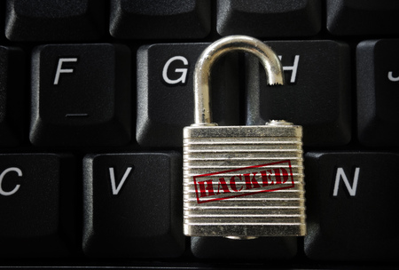 Broken lock with Hacked label on a computer keyboard -- data breach conceptの写真素材