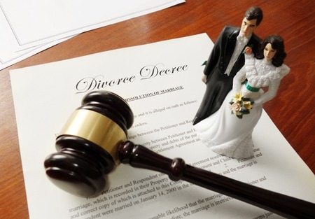 Divorce decree and gavel with bride and groom coupleの写真素材