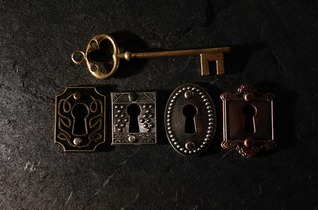 Four vintage locks with a gold keyの写真素材