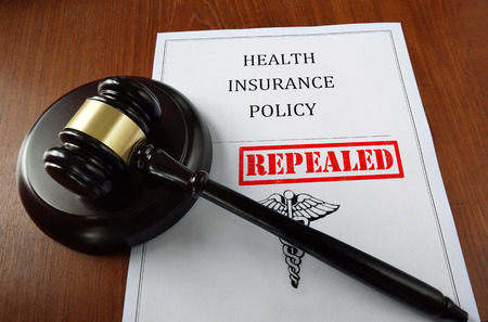 Health Insurance Policy document with court gavel and Repealed stampの写真素材