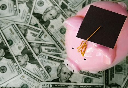 piggy bank with graduation cap on cashの写真素材