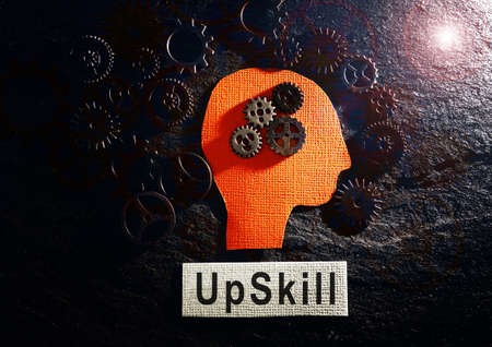 Head and gears with Upskill text on textured backgroundの写真素材