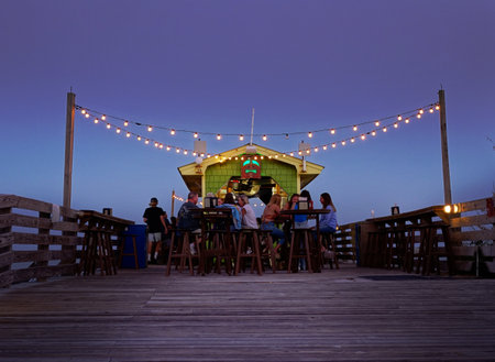 Carolina Beach, NC - USA - 09-26-2021: People enjoying drinks at the outdoor tiki bar at the Ocean Grill restaurant in Carolina Beach NCのeditorial素材