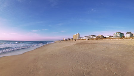 Panoramic view of the beach and buildings on a sunny dayの写真素材