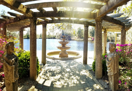 Beautiful fountain and trellis on the lake in Airlie Gardens , Wilmington , North Carolinaの写真素材
